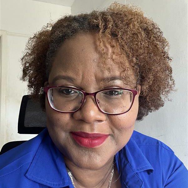 Domini H Woman in a blue suit smiling